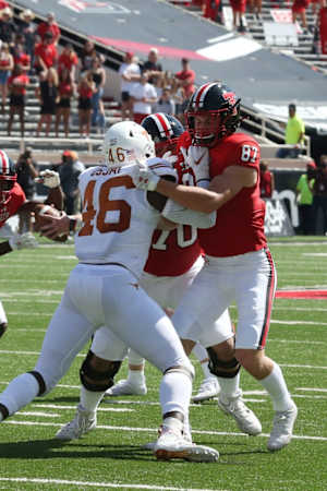 Sep 26, 2020; Lubbock, Texas, USA; Texas Tech Red Raiders tight end John Holcomb (87) blocks Texas Longhorns defensive back Joseph Ossai (46) in the first half at Jones AT&T Stadium. Mandatory Credit: Michael C. Johnson-USA TODAY Sports